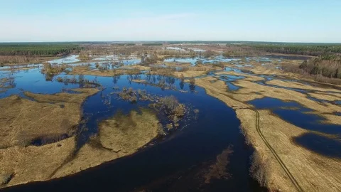 4K. Flight over flooded blue river in spring, aerial panoramic view. Stock Footage 73800679