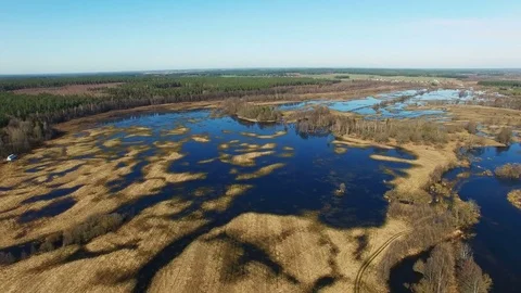 4K. Flight over flooded blue river in early spring, aerial panoramic view. Video stock 85038817