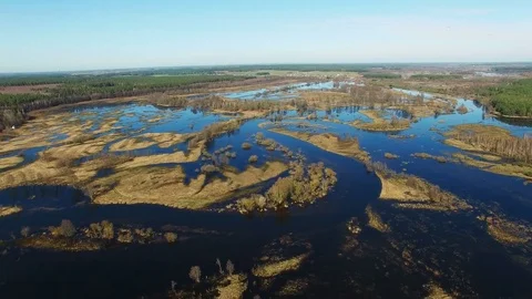 4K. Flight over flooded blue river in early spring, aerial panoramic view. Video stock 85039228
