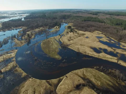 4K. Flight over flooded blue river in early spring, aerial panoramic view. Video stock 85039668