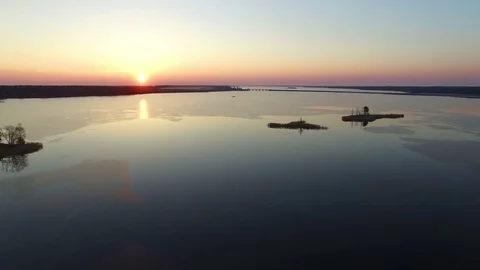 4K. Flight over large frozen lake with bridge in winter on sunset, aerial view. Video stock 82179540