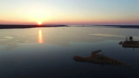 4K. Flight over large frozen lake with bridge in winter on sunset, aerial view. 動画素材 82179672