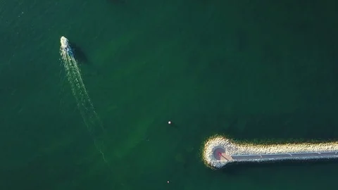 4K. Flight over marina with floating yachts and lighthouse, aerial top view. Video stock 78479636