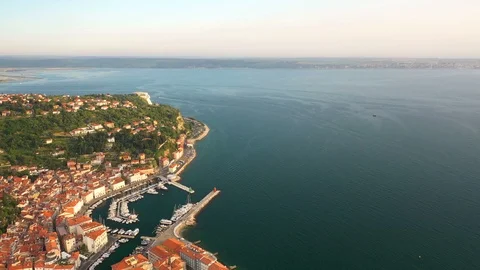 4K. Flight over old city Piran at golden sunset, aerial panoramic view. Video stock 111174114