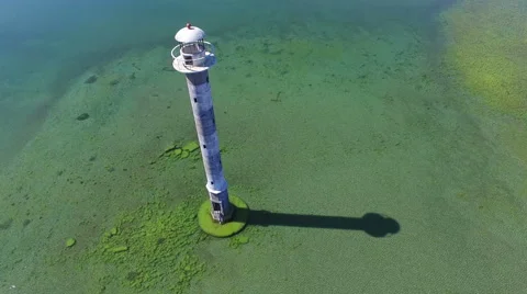 4K. Flight over old lighthouse standing in the sea, aerial panoramic view. Video stock 63071321