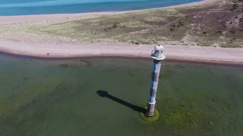 4K. Flight over old lighthouse standing in the sea, aerial panoramic view. Video stock 63071594