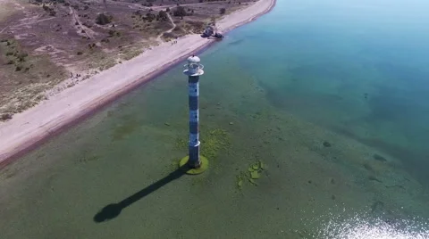 4K. Flight over old lighthouse standing in the sea, aerial panoramic view. Stock-Footage 63072000