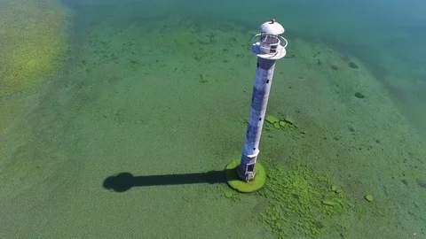 4K. Flight over old lighthouse standing in the sea, aerial view. Video stock 72183510