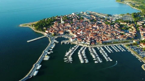 4K. Flight over old town Izola in Slovenia, aerial view with marina at sunset. Stock Footage