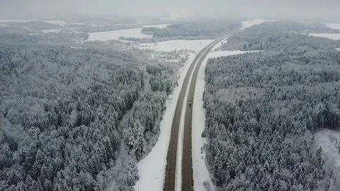 4K. Flight over road in winter forest with driving cars. Aerial vanishing point. 스톡 동영상 84264793