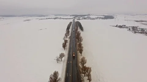 4K. Flight over Winter road with driving cars on the north. Aerial. Video stock 102332149