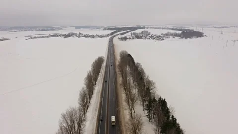 4K. Flight over Winter road with driving cars on the north. Aerial. Video stock 102332219