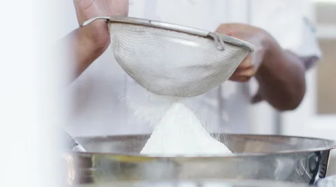 4K Flour being emptied through a sieve into a mixing bowl Stock Footage 56193749