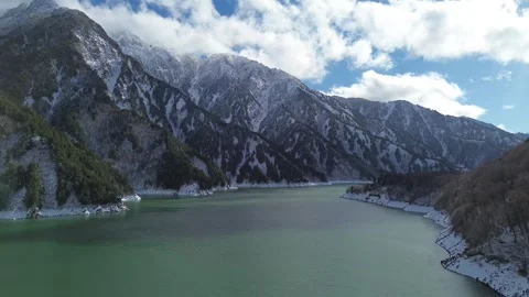 4K Fly-Over Dam in Winter with Snow-Covered Trees, Captured by Drone 스톡 동영상 257786787