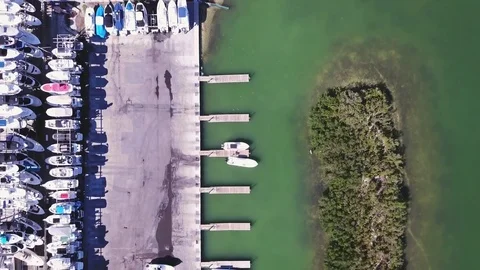 4k Fly over marina, docks, boats, island, green water 스톡 동영상 82800990
