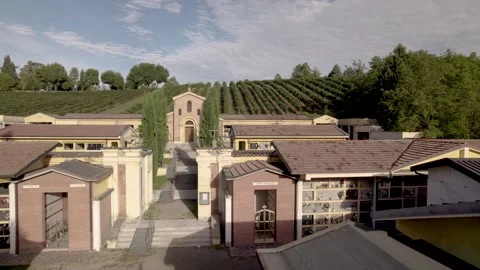 4K fly over an old cemetery among green vineyards in Levizzano Village in Emilia Stock Footage 297353355