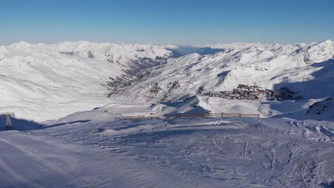 4k fly towards Val Thorens from the top of the mountain with a perfect blue sky Stock Footage 125481216