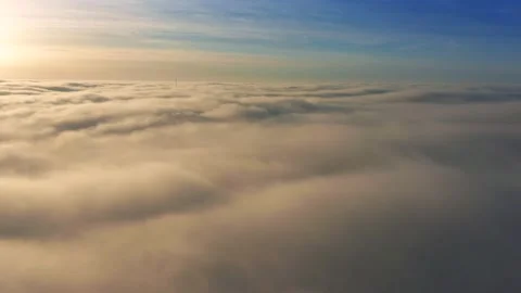 4K Flying above the clouds with beautiful golden clouds at sunrise Video stock 229608086