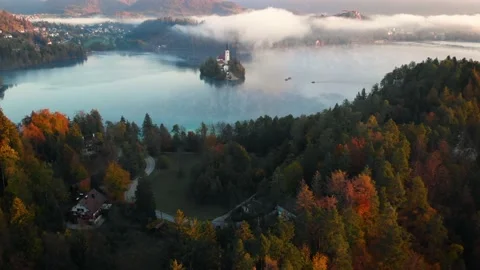 4K Flying around romantic Bled lake with chapel on the island at foggy sunrise Stock Footage 130272856
