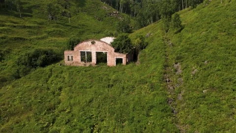 4K Flying over an abandoned, destroyed building in a mountain gorge. Stock Footage 159526333