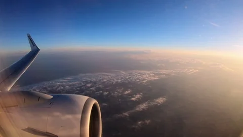 4K. Flying over the clouds in an airplane while is is dawning-Adrian Stock Footage 90619055