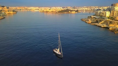 4K flying over a sailboat at St.Elmo bay early in the morning, Valletta, Malta Stock Footage 91785740