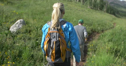 4k Following couple hiking Colorado mountain trail Stock Footage