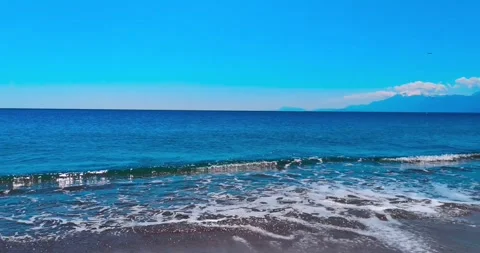 4K Footage of a Beautiful Beach with Clear Blue Waters and Scenic Coastline Stock Footage 346457767