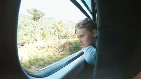 4K footage of boy riding in train sticking his head out from window Stock-Footage 102711894