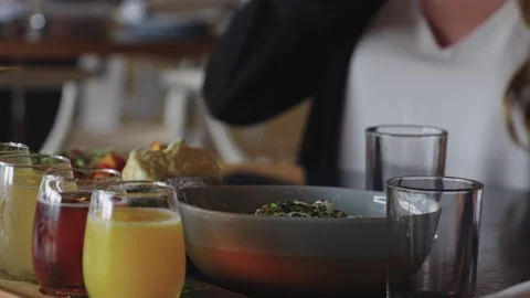 4K footage of a brunch table featuring healthy Caesar salad and fresh juices Stock Footage 332099191