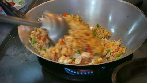 4K footage, Close up chef hand cooking Thai style Fried Rice in Old Frying Pan. Stock-Footage 78018513