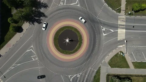 4k footage of a drone hovering over a ring road with cars passing through it Stock Footage 195739466
