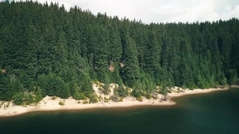 4k footage of drone orbiting around mountain lake shore Stock Footage 251786531