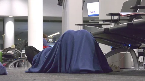 4K footage: Stranded sleeping airline travelers Stock Footage 114816033