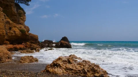 4K footage of a waves breaking against a beautiful white sand beach in the Spain Stock Footage 112263338