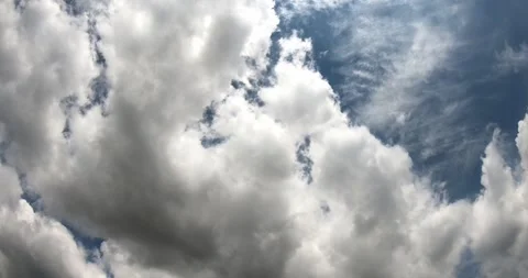 4K footage of White Clouds Moving Across a Blue Sky Stock Footage 346494304