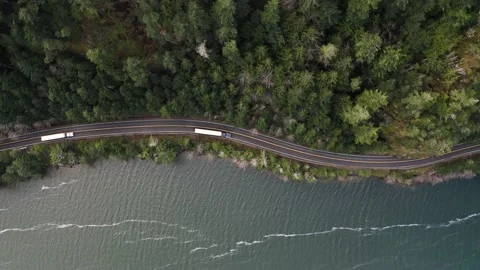 4k Forest Transport Trucks Semi-Trucks Haul Cargo Winding Mountain Lake Highway Stock Footage 170901067
