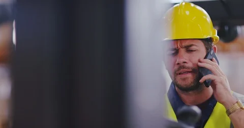 4K Forklift truck driver talking on the phone while operating the vehicle Stock Footage 101932755