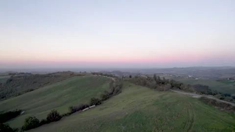 4K forward drone flight over green fields at dusk in Castelvetro di Modena Stock Footage 296602726