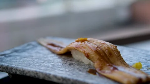 4K fottage. Place the conger eel nigiri sushi on the counter. Stock Footage 313759546