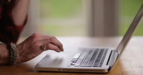 4K Freelance worker at home, working on laptop &amp; making phone call to his office Stock Footage 61784983