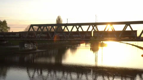 4k. freight train passing a bridge  over Weser river during sunset, Bremen. Video stock 194543300