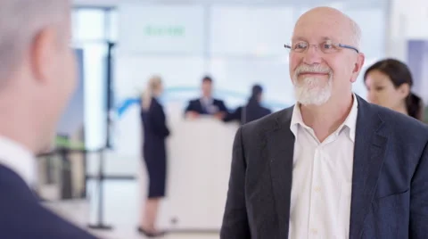 4K Friendly bank worker talking to customer &amp; offering advice about a loan Stock Footage 64301684