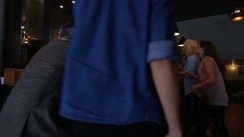 4K Friendly Bar Staff Serving Young Fun Crowd In Fashionable City Bar Stock Footage 75637586