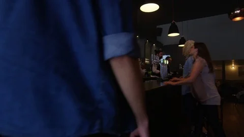 4K Friendly Bar Staff Serving Young Fun Crowd In Fashionable City Bar Video stock 75637976