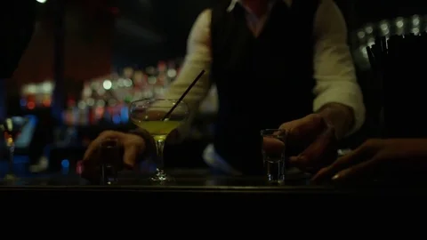 4K Friendly Barman Serving Shots To Female Friends In Nightclub Video stock 75654562