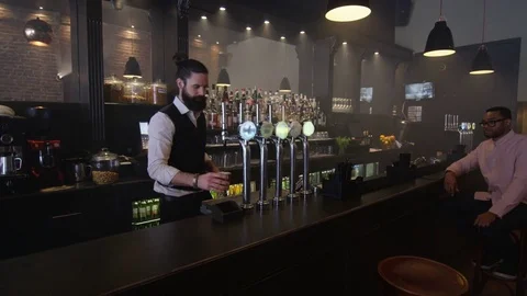 4K Friendly Bartender Serving &amp; Chatting With Customer In Trendy Bar Video stock 75607871