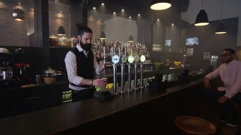 4K Friendly Bartender Serving &amp; Chatting With Customer In Trendy Bar Video stock 75608660