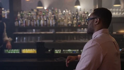 4K Friendly Bartender Serving &amp; Chatting With Customer In Trendy Bar Video stock 75609277