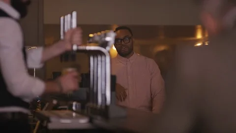 4K Friendly Bartender Serving &amp; Chatting With Customers In City Bar Stock Footage 75757191